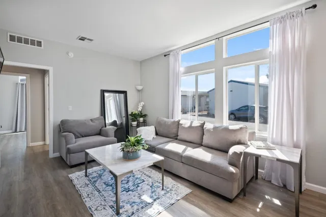 a living room with furniture and a large window