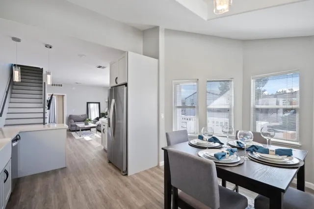 a view of a dining room with furniture and wooden floor