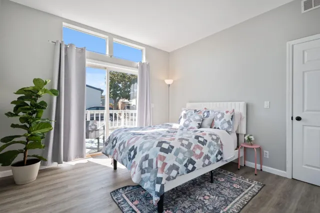 a bedroom with a bed and a potted plant