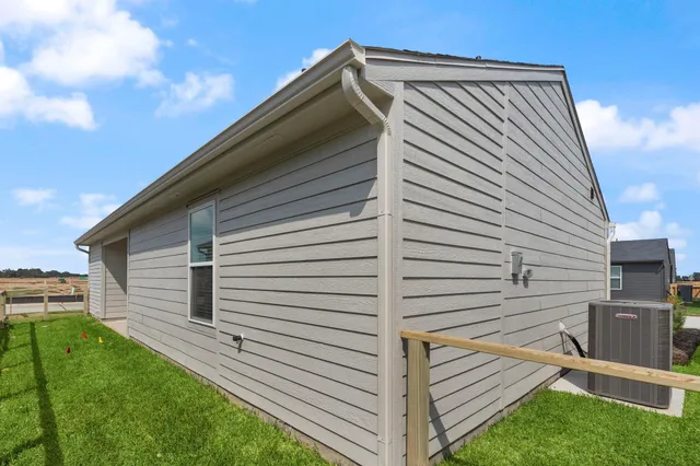 a car parked in front of a house with a yard