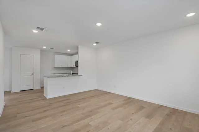 a kitchen with granite countertop a sink a stove a microwave and cabinets