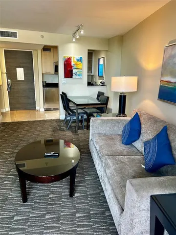 a living room with furniture and a rug