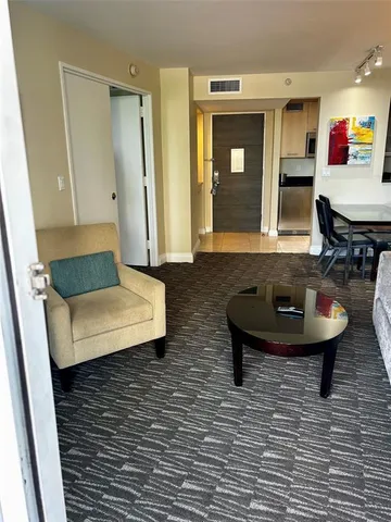 a living room with furniture and a mirror