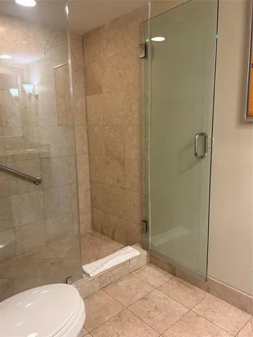 a bathroom with a toilet and a shower