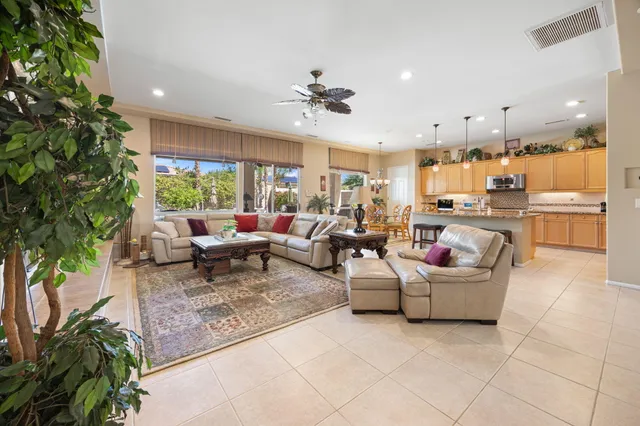 a living room with fireplace furniture and a potted plant