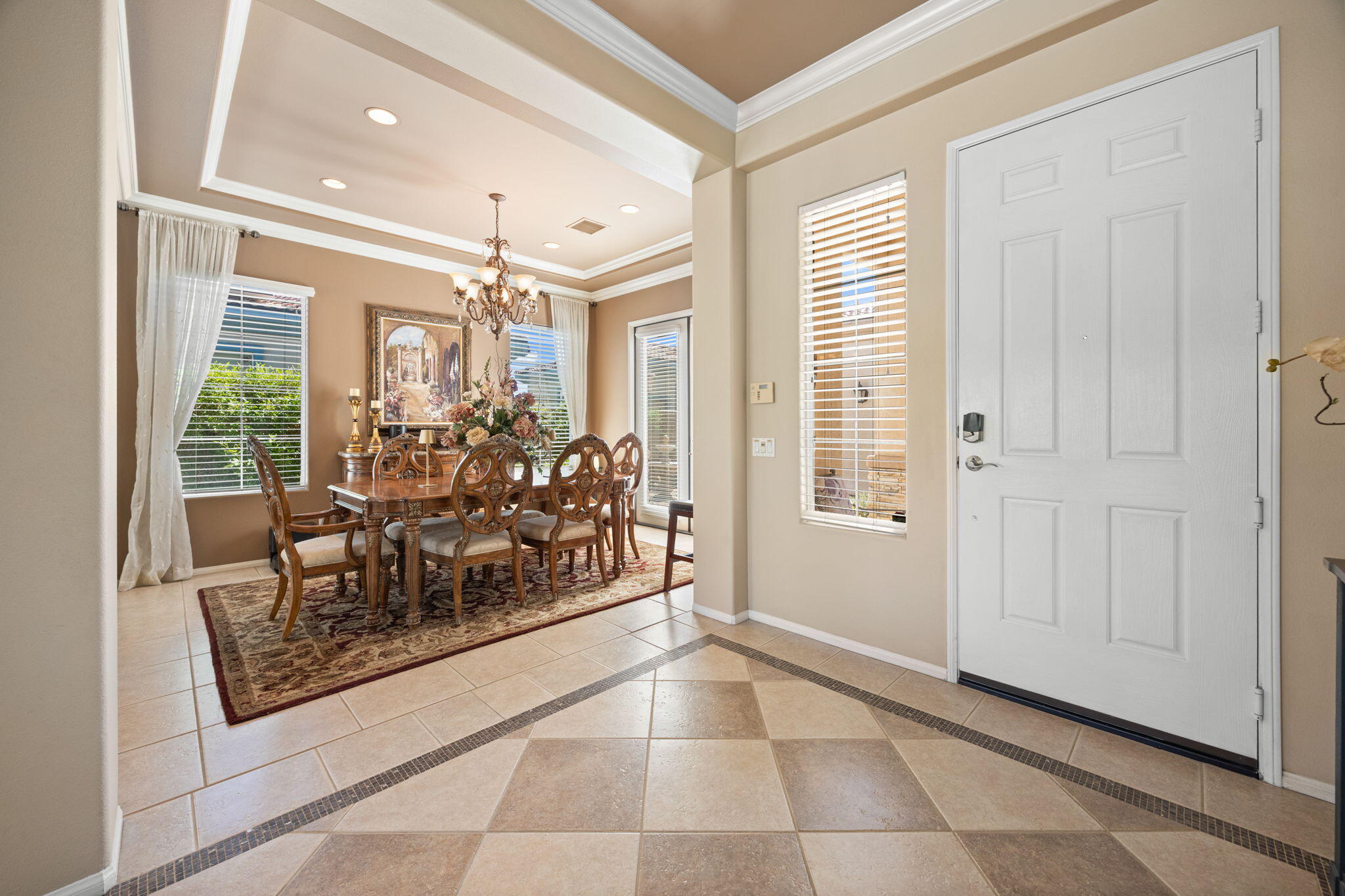 74068 Kokopelli Circle Palm Desert, CA 92211 - Photo 16 of 46 a view of a hallway with a dining table and chairs