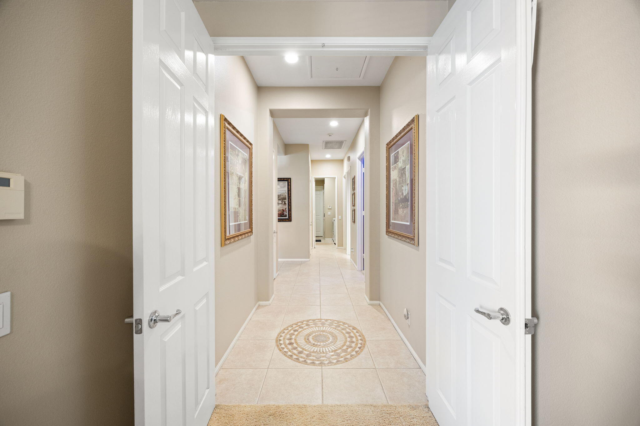 74068 Kokopelli Circle Palm Desert, CA 92211 - Photo 18 of 46 a view of a hallway with wooden floor and a bathroom