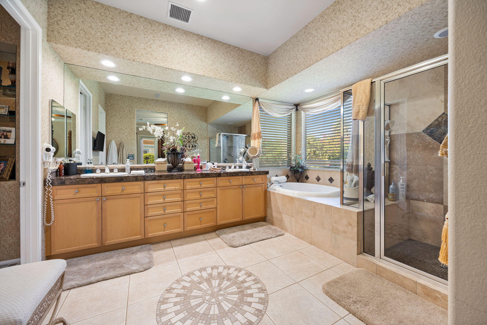 74068 Kokopelli Circle Palm Desert, CA 92211 - Photo 23 of 46 a large bathroom with a large mirror vanity and shower