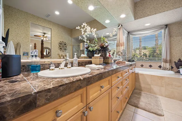 a large bathroom with double vanity and a bathtub