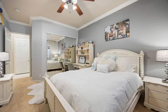 a bedroom with a large bed and a chandelier