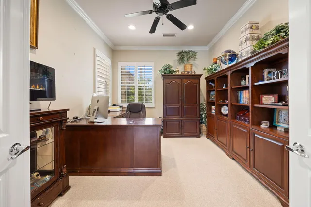 a view of kitchen with cabinets and window