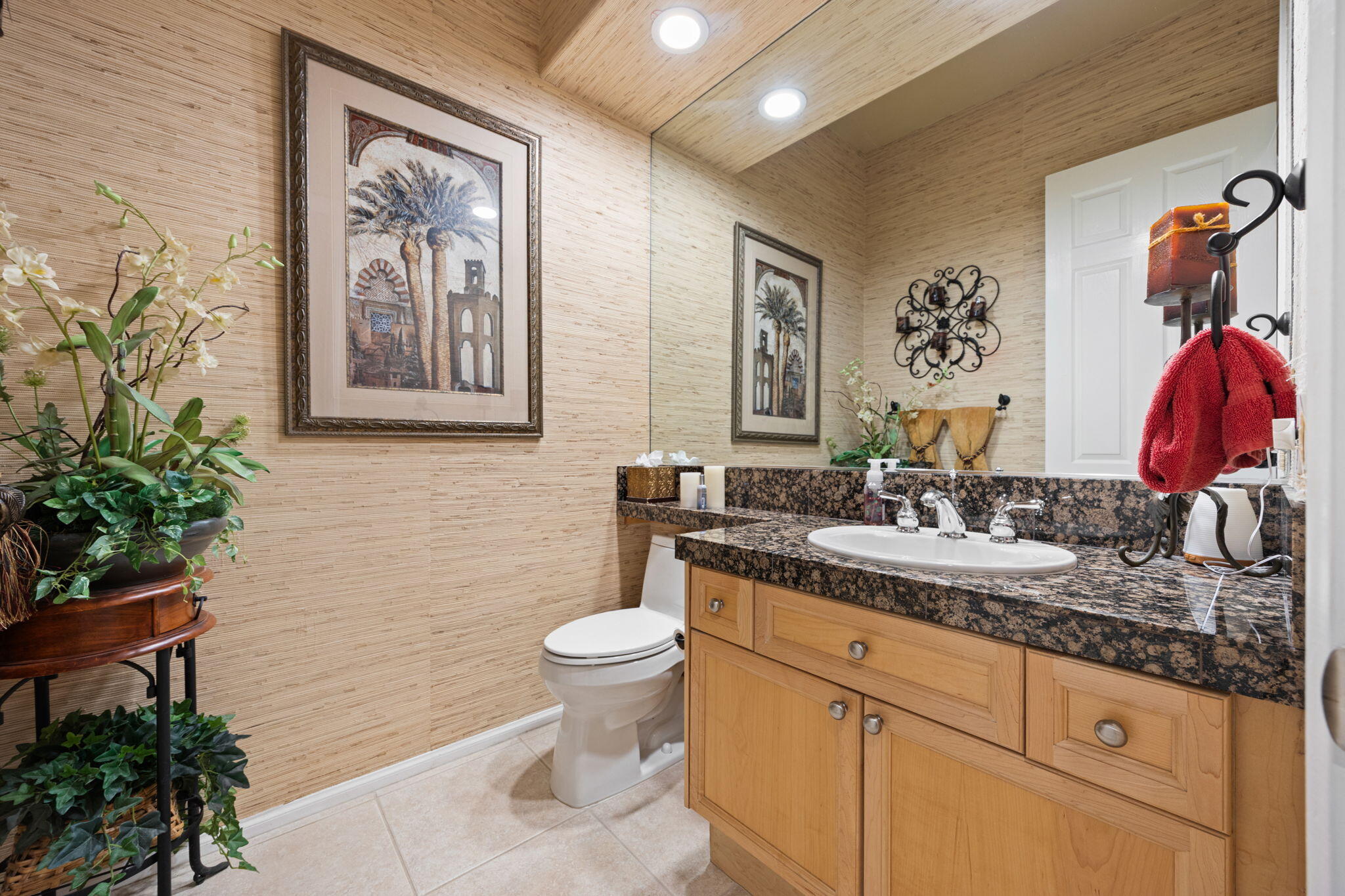 74068 Kokopelli Circle Palm Desert, CA 92211 - Photo 35 of 46 a bathroom with a granite countertop sink a toilet and a mirror