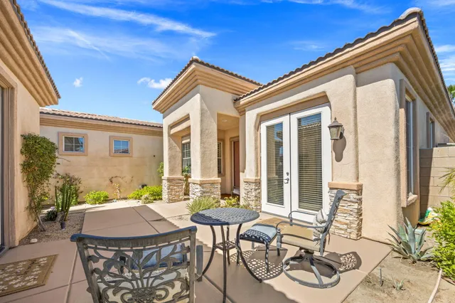 a view of a patio with table and chairs and potted plants