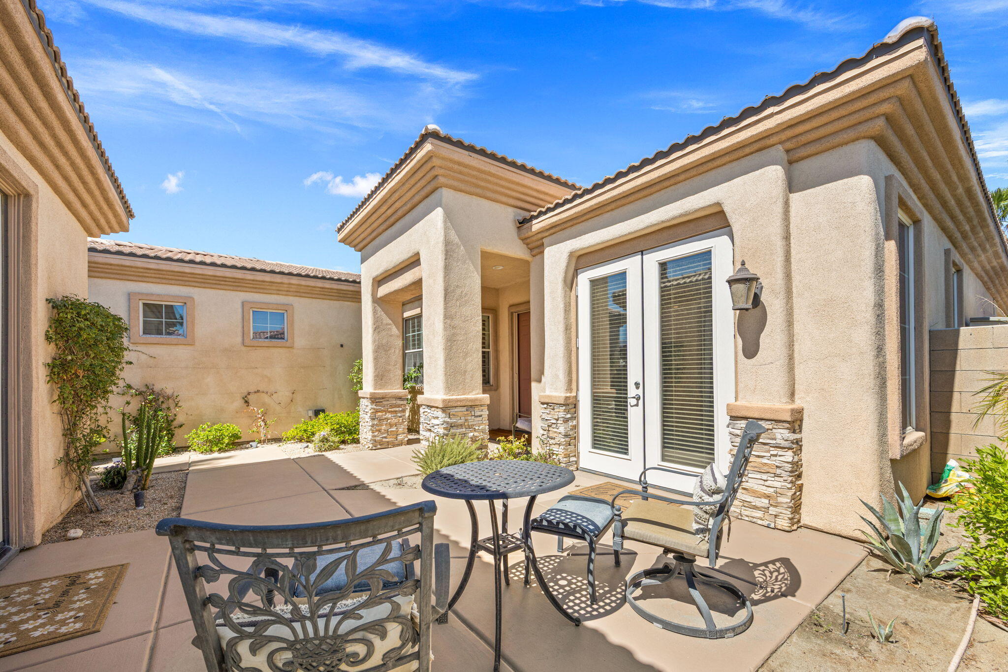 74068 Kokopelli Circle Palm Desert, CA 92211 - Photo 5 of 46 a view of a patio with table and chairs and potted plants