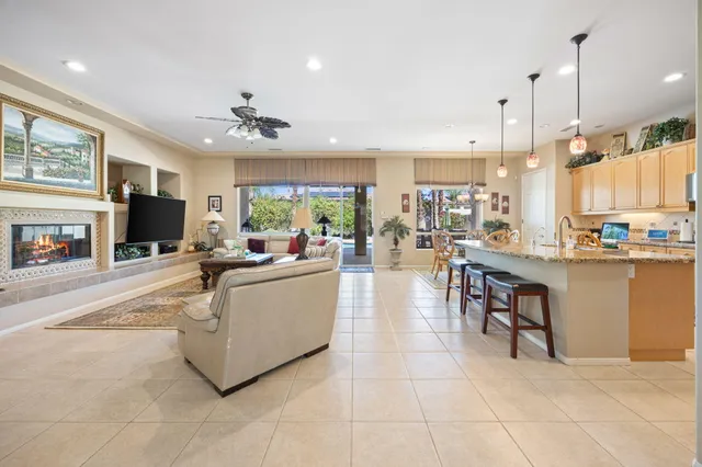 a living room with furniture a dining table and a fireplace