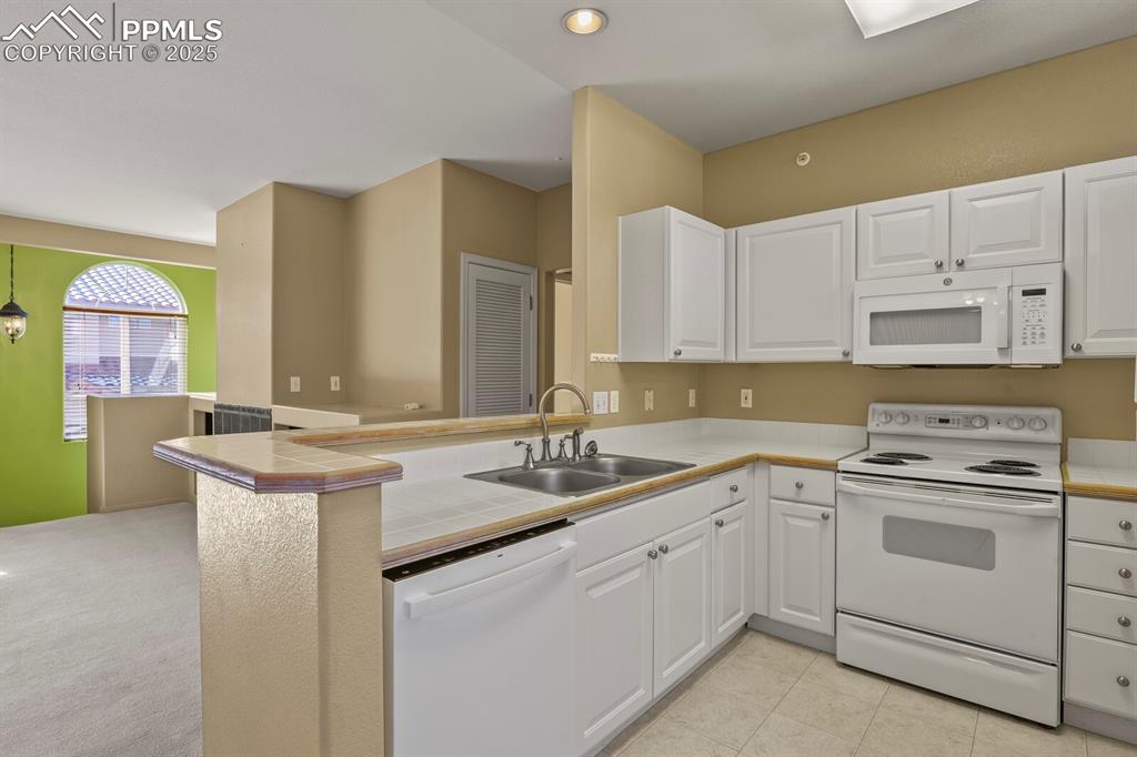 3271 Apogee View Colorado Springs, CO 80906 - Photo 15 of 37 a kitchen with a sink stove and cabinets