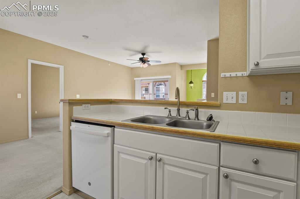 3271 Apogee View Colorado Springs, CO 80906 - Photo 16 of 37 a kitchen with a sink and cabinets