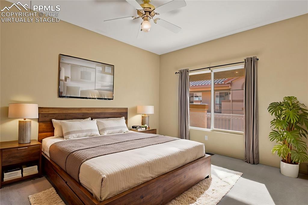 3271 Apogee View Colorado Springs, CO 80906 - Photo 18 of 37 a bedroom with a bed and a potted plant