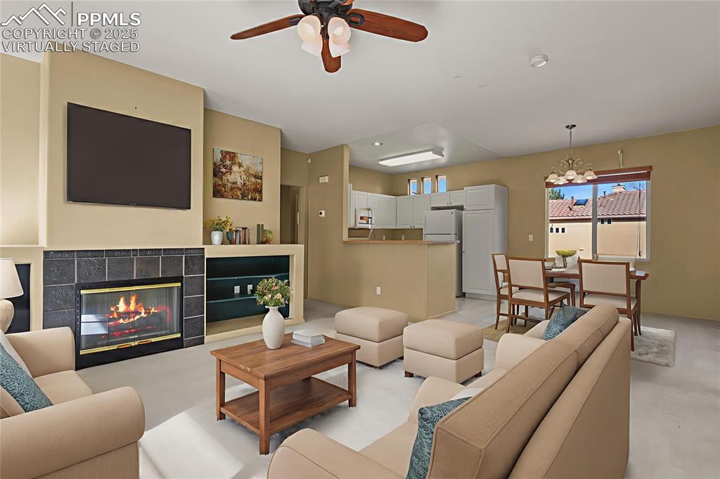 3271 Apogee View Colorado Springs, CO 80906 - Photo 7 of 37 a living room with furniture and a fireplace
