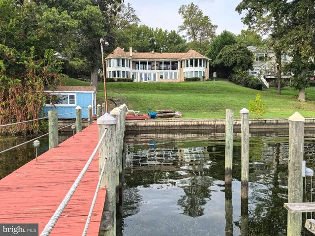 a view of a house with backyard porch and sitting area