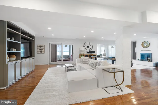 a living room with furniture a flat screen tv and a rug