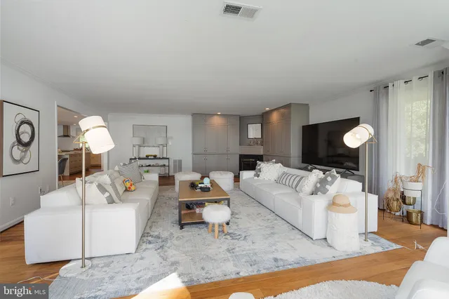 a living room with furniture and a large mirror