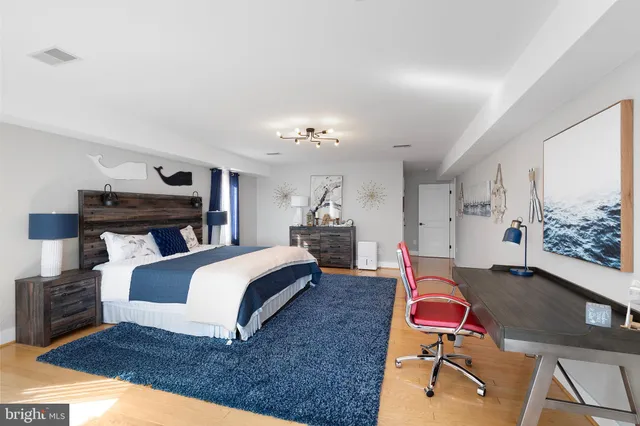 a bed room with a bed window and a chair