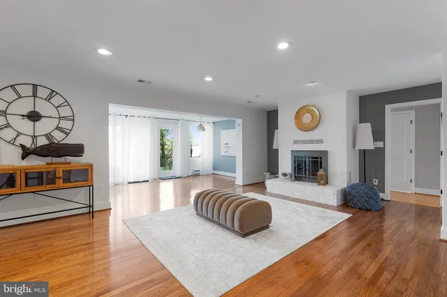 a living room with fireplace furniture and a wooden floor