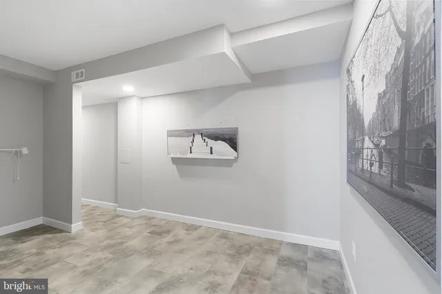 a very nice looking room with wooden floor and furniture