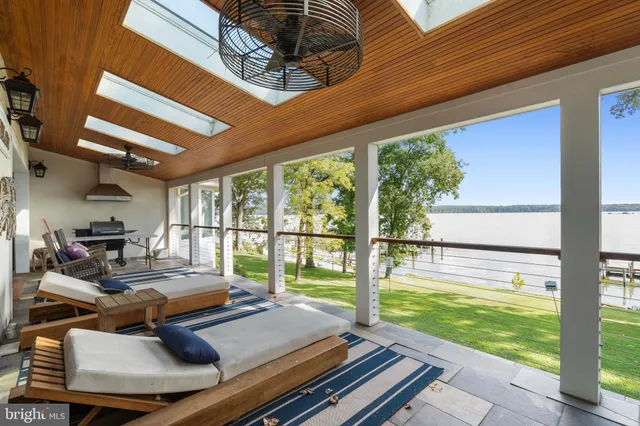 a view of a patio with table and chairs and wooden floor