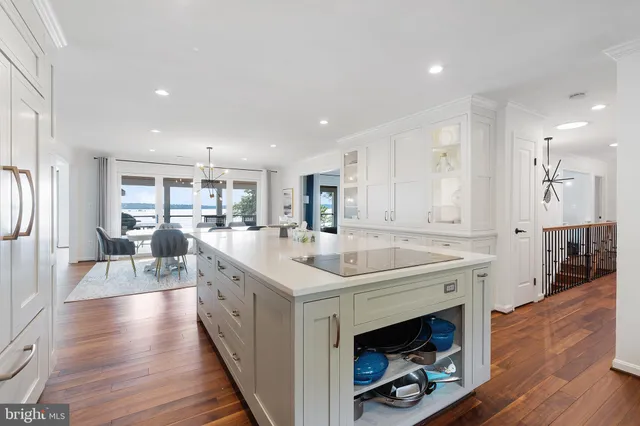 a large kitchen with stainless steel appliances lots of counter space and wooden floor