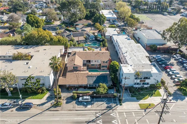 an aerial view of residential houses with yard