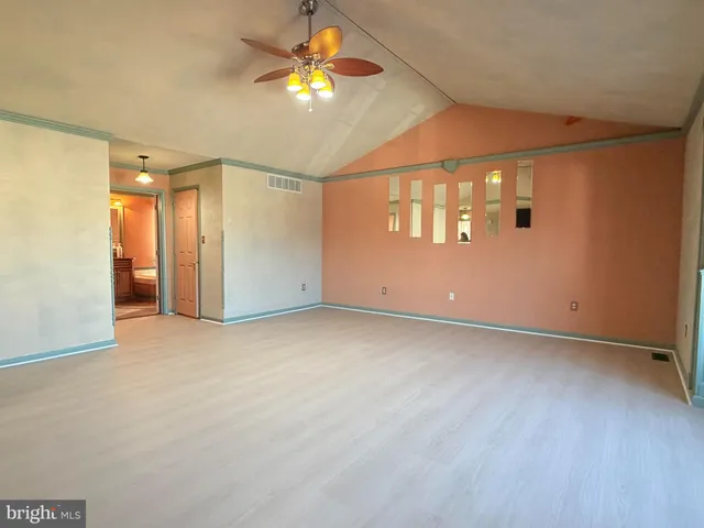 an empty room with a empty space and a ceiling fan