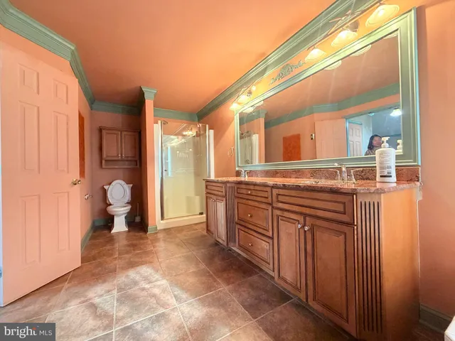 a large bathroom with a granite countertop sink and a mirror
