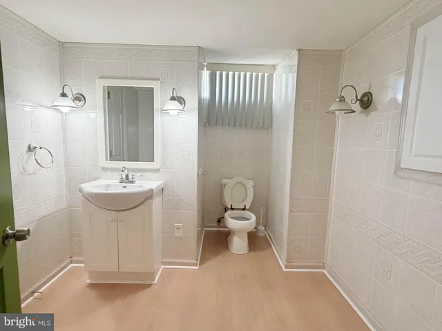 a bathroom with a sink a toilet and mirror