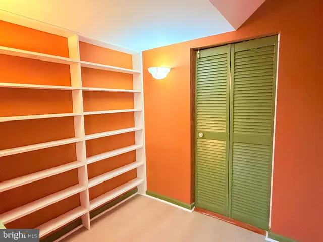 a view of a room with a door and a window