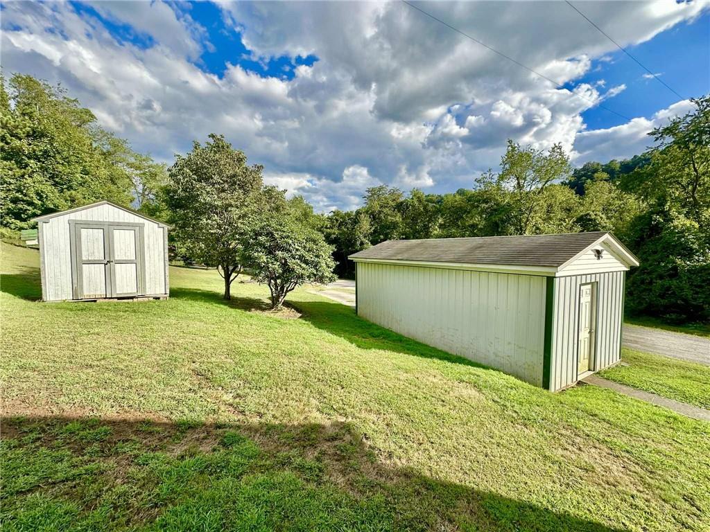 143 Raineytown Road Dawson, PA 15428 - Photo 11 of 42 a backyard of a house with lots of green space