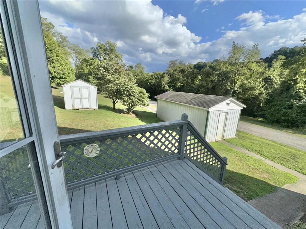 143 Raineytown Road Dawson, PA 15428 - Photo 19 of 42 a view of a table and chairs in the balcony