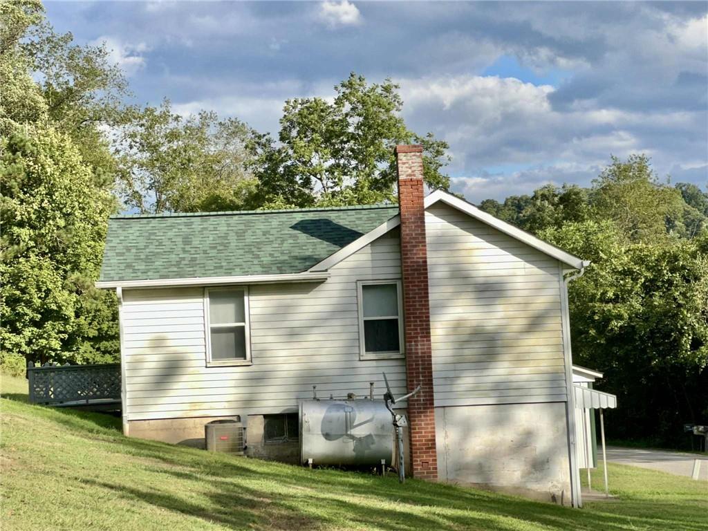 143 Raineytown Road Dawson, PA 15428 - Photo 24 of 42 a view of a house with a yard