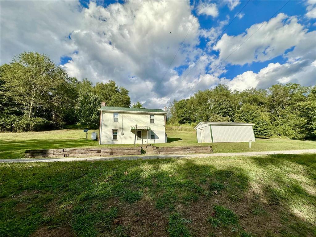 143 Raineytown Road Dawson, PA 15428 - Photo 4 of 42 a view of a house with pool and a yard