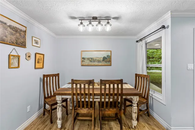 a view of a dining room with furniture and a chandelier