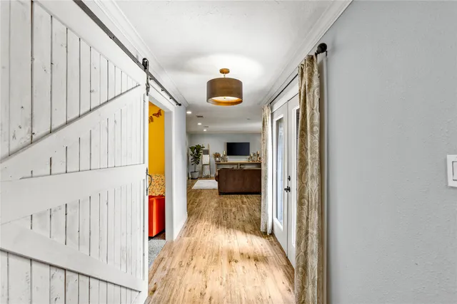 a view of a hallway view with wooden floor and staircase