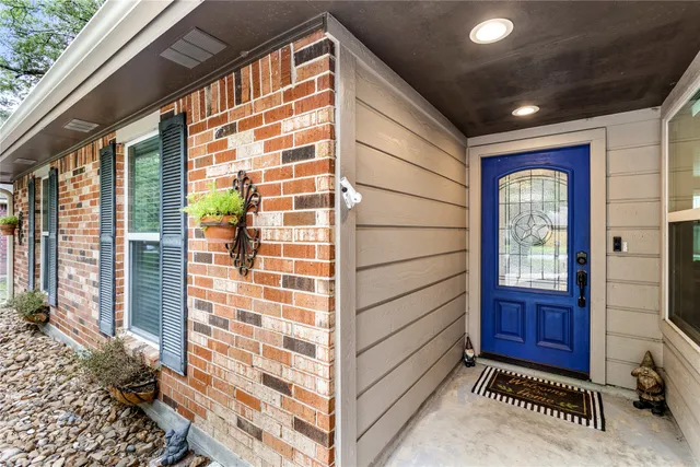 a view of front door with a potted plant and a window