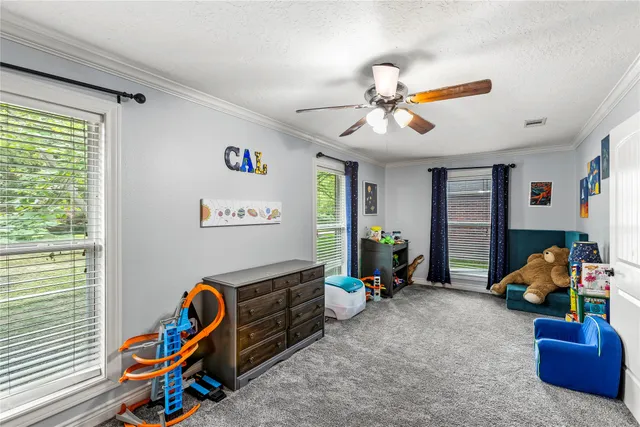 a living room with furniture and a gym