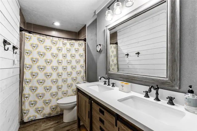 a bathroom with a sink toilet and shower