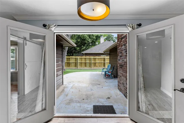 a view of a room with wooden floor and a floor to ceiling window