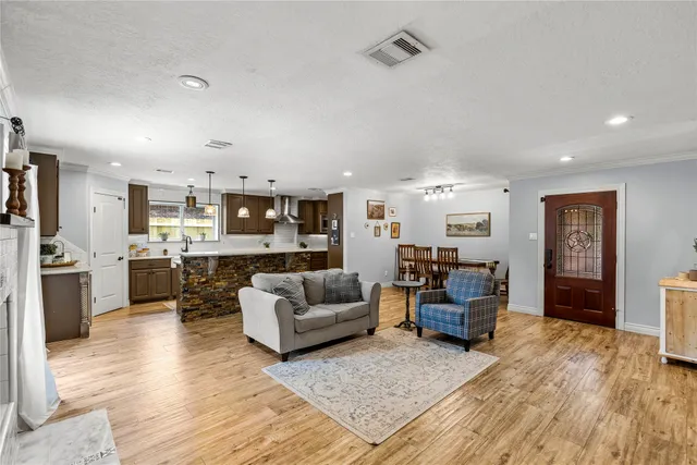 a living room with furniture and kitchen view