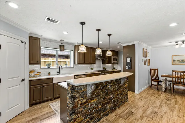 a large kitchen with a table and chairs