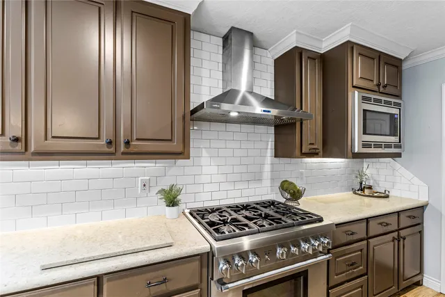 a stove top oven sitting inside of a kitchen