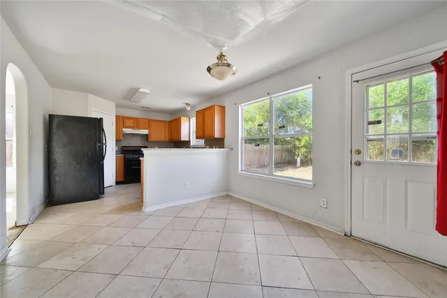 a view of a kitchen with an entryway and a window